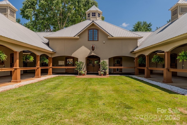 650 Golf Course Rd, Columbus, NC 28722 - rear view of house featuring a metal roof, a lawn, and stucco siding