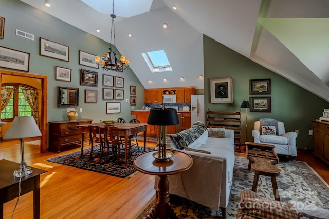 650 Golf Course Rd, Columbus, NC 28722 - living area featuring a skylight, wood finished floors, high vaulted ceiling, a chandelier, and recessed lighting