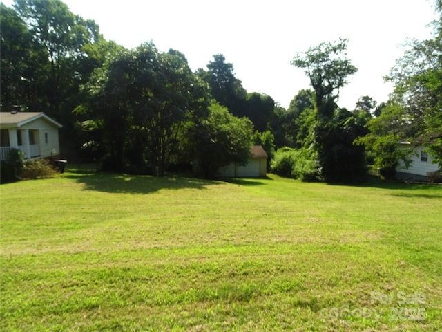 113 Dillon St, Winston Salem, NC 27107 - view of grassy yard with a garage