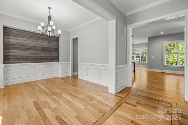 4930 Killian Crossing Dr, Denver, NC 28037 - unfurnished dining area featuring a chandelier, light wood-style floors, ornamental molding, and a wainscoted wall