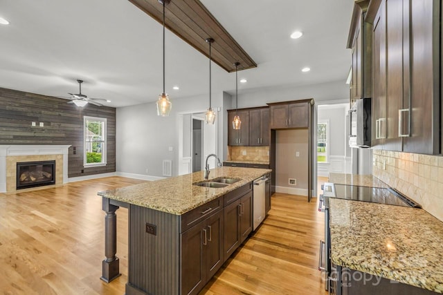 4930 Killian Crossing Dr, Denver, NC 28037 - kitchen featuring stainless steel appliances, ceiling fan, dark brown cabinets, a breakfast bar, and light wood-type flooring