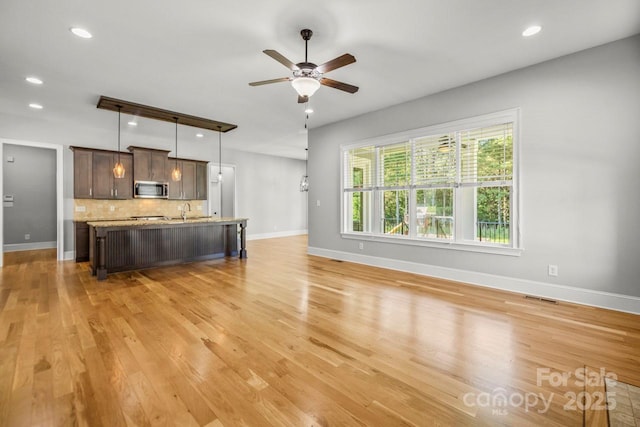 4930 Killian Crossing Dr, Denver, NC 28037 - unfurnished living room featuring a ceiling fan, light wood-style flooring, and recessed lighting