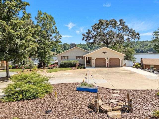 643 Lake Dr Unit 10, Lexington, NC 27292 - view of front of house featuring concrete driveway, a chimney, a garage, and a water view