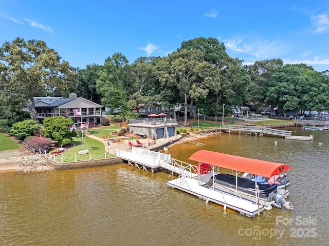 643 Lake Dr Unit 10, Lexington, NC 27292 - dock area featuring a water view, boat lift, a lawn, and view of wooded area