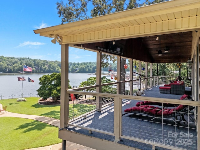 643 Lake Dr Unit 10, Lexington, NC 27292 - wooden terrace with a water view, a ceiling fan, and a lawn