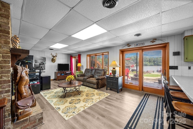 643 Lake Dr Unit 10, Lexington, NC 27292 - living area with a drop ceiling, light wood-style flooring, and wooden walls