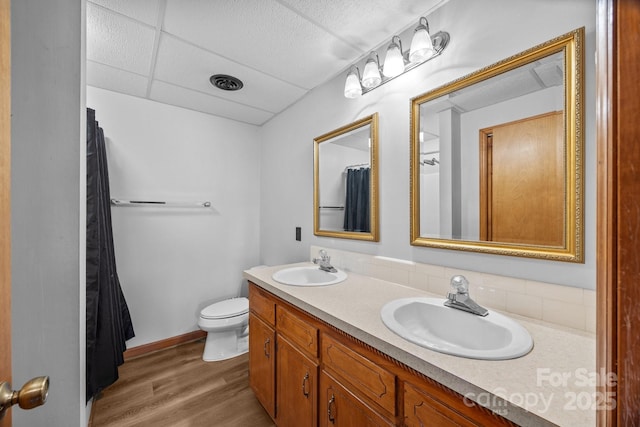 643 Lake Dr Unit 10, Lexington, NC 27292 - full bathroom featuring double vanity, wood finished floors, and a shower with shower curtain