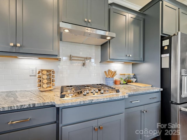 10305 Superb Ln, Charlotte, NC 28215 - kitchen with stainless steel appliances, under cabinet range hood, decorative backsplash, and light stone countertops