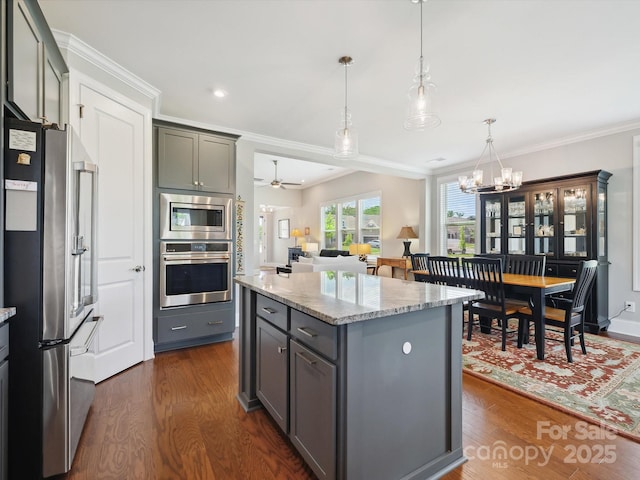 10305 Superb Ln, Charlotte, NC 28215 - kitchen with stainless steel appliances, dark wood-style flooring, gray cabinets, a chandelier, and a kitchen island