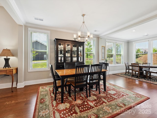 10305 Superb Ln, Charlotte, NC 28215 - dining space with a chandelier, healthy amount of natural light, wood finished floors, and crown molding