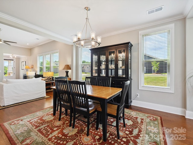 10305 Superb Ln, Charlotte, NC 28215 - dining area featuring a chandelier, wood finished floors, crown molding, and ceiling fan
