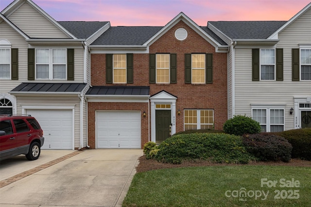 4208 Carl Parmer Dr, Harrisburg, NC 28075 - multi unit property with brick siding, concrete driveway, an attached garage, a standing seam roof, and roof with shingles