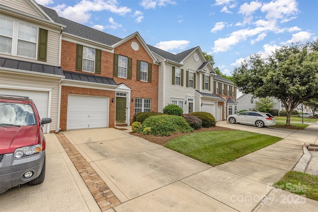 4208 Carl Parmer Dr, Harrisburg, NC 28075 - townhome / multi-family property with brick siding, driveway, a garage, a residential view, and a standing seam roof