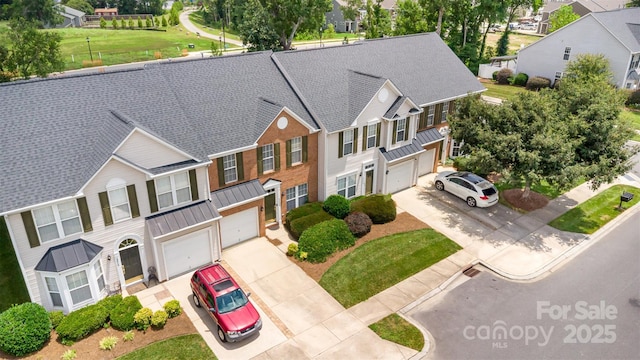 4208 Carl Parmer Dr, Harrisburg, NC 28075 - view of front of house with a standing seam roof, driveway, a garage, and a residential view