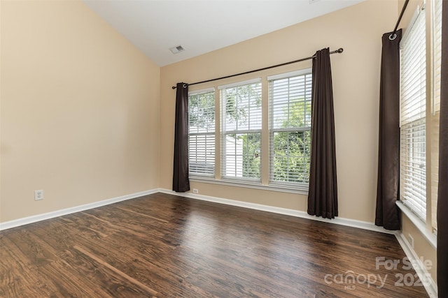 4208 Carl Parmer Dr, Harrisburg, NC 28075 - empty room featuring vaulted ceiling, plenty of natural light, and dark wood-style flooring