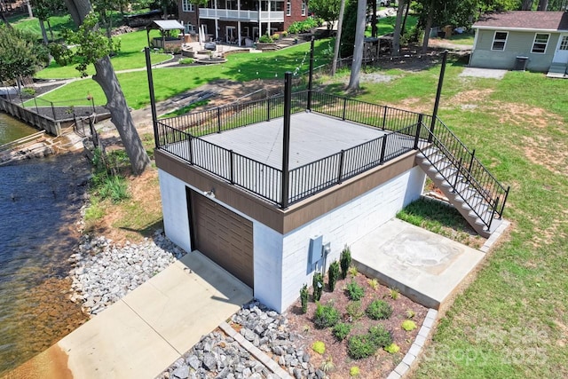 172 Honeydew Cir, Troutman, NC 28166 - view of home's community featuring a water view, stairs, a detached garage, and a lawn