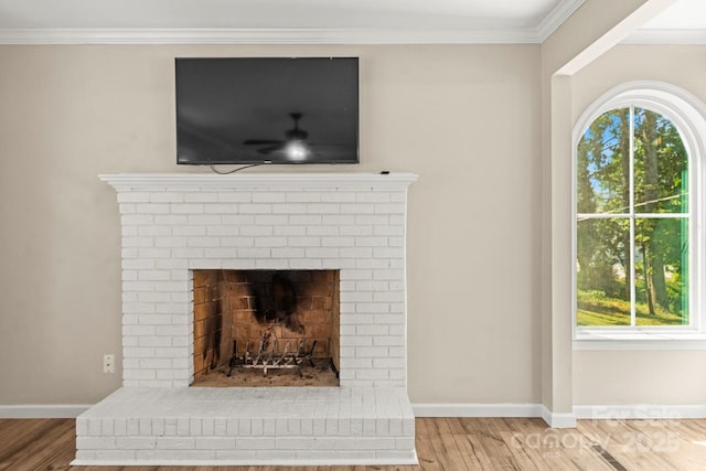 172 Honeydew Cir, Troutman, NC 28166 - detailed view of wood finished floors, ornamental molding, and a brick fireplace