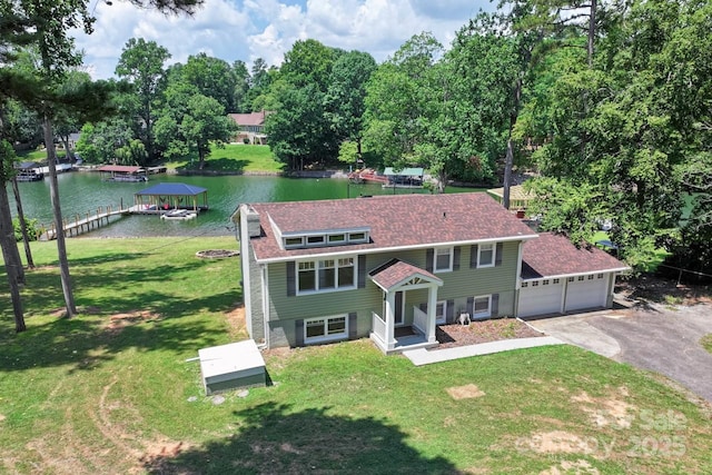 172 Honeydew Cir, Troutman, NC 28166 - view of front of property featuring a water view, a front lawn, a shingled roof, driveway, and view of wooded area