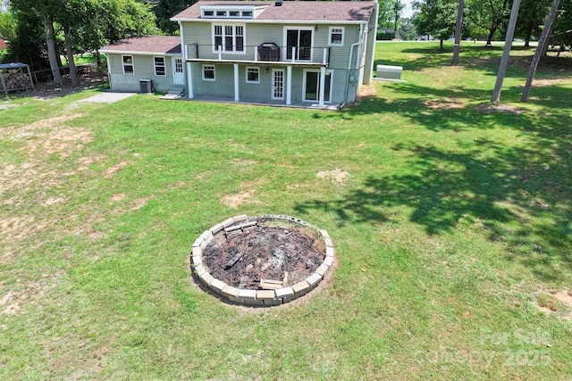 172 Honeydew Cir, Troutman, NC 28166 - back of house featuring a patio area, a fire pit, and a lawn