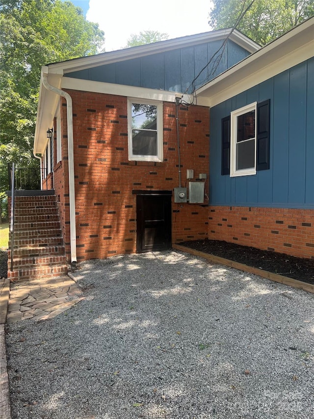1320 Kings Cir, Shelby, NC 28150 - view of home's exterior featuring brick siding, board and batten siding, and stairs