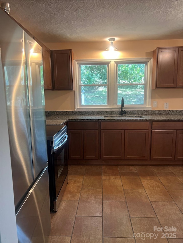 1320 Kings Cir, Shelby, NC 28150 - kitchen featuring appliances with stainless steel finishes, healthy amount of natural light, and dark stone counters