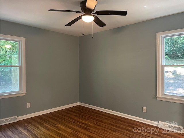 1320 Kings Cir, Shelby, NC 28150 - spare room featuring dark wood-style floors, plenty of natural light, and a ceiling fan