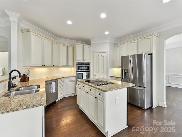 4032 Cambridge Hill Ln, Charlotte, NC 28270 - kitchen with stainless steel appliances, arched walkways, cream cabinetry, ornamental molding, and light stone counters