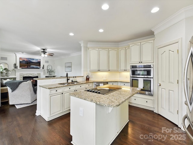 4032 Cambridge Hill Ln, Charlotte, NC 28270 - kitchen with cream cabinets, crown molding, a peninsula, a center island, and a ceiling fan