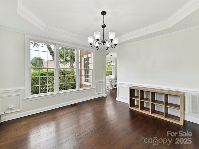 4032 Cambridge Hill Ln, Charlotte, NC 28270 - unfurnished dining area featuring a chandelier, ornamental molding, wainscoting, wood finished floors, and arched walkways