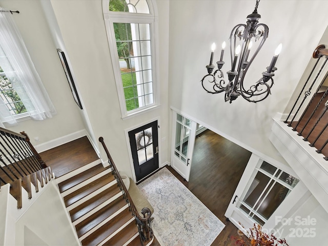 4032 Cambridge Hill Ln, Charlotte, NC 28270 - foyer entrance featuring a chandelier, stairs, plenty of natural light, wood finished floors, and a towering ceiling