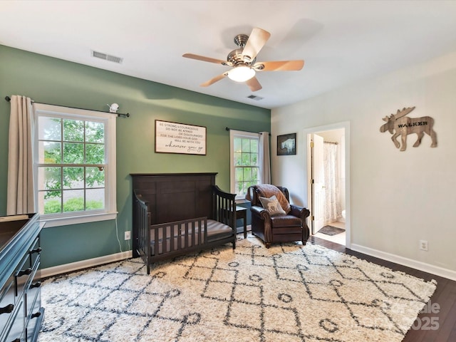 4032 Cambridge Hill Ln, Charlotte, NC 28270 - bedroom featuring multiple windows, wood finished floors, a ceiling fan, and a crib
