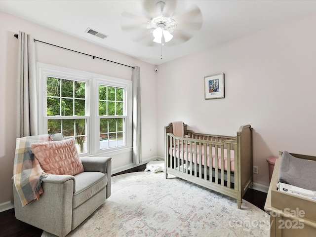 4032 Cambridge Hill Ln, Charlotte, NC 28270 - bedroom with wood finished floors, ceiling fan, and a nursery area