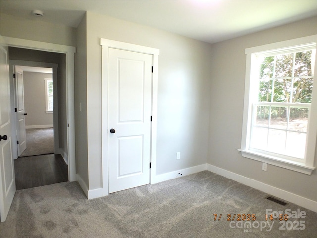 1732 Rocky River Rd, Lancaster, SC 29720 - unfurnished bedroom featuring multiple windows and carpet
