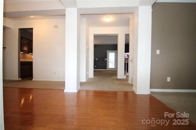 2418 Alaqua Ct, Matthews, NC 28105 - spare room featuring ornate columns and light wood-style flooring