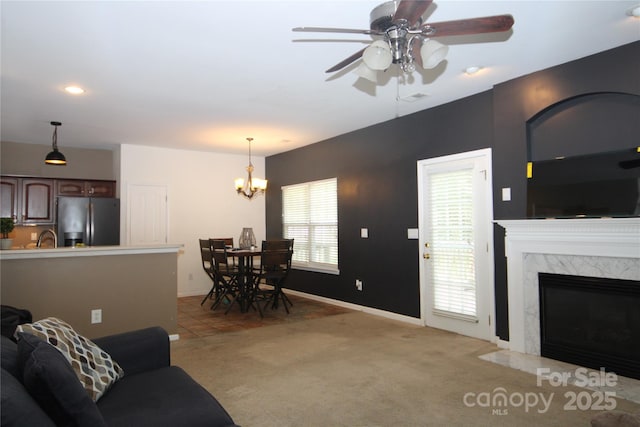 2418 Alaqua Ct, Matthews, NC 28105 - living area with light carpet, ceiling fan, a chandelier, a fireplace, and recessed lighting