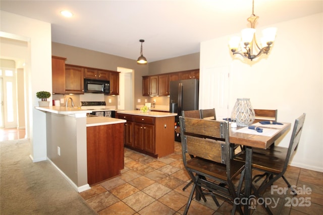 2418 Alaqua Ct, Matthews, NC 28105 - kitchen with black microwave, stainless steel fridge with ice dispenser, range with electric cooktop, light countertops, and a chandelier