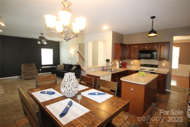 2418 Alaqua Ct, Matthews, NC 28105 - dining room featuring healthy amount of natural light, a chandelier, a ceiling fan, and stairway
