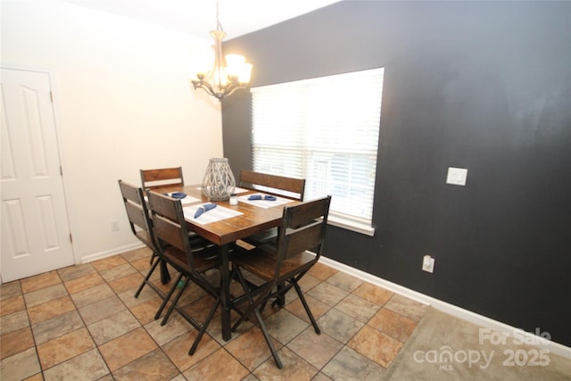 2418 Alaqua Ct, Matthews, NC 28105 - dining area with a chandelier and light stone finish floors