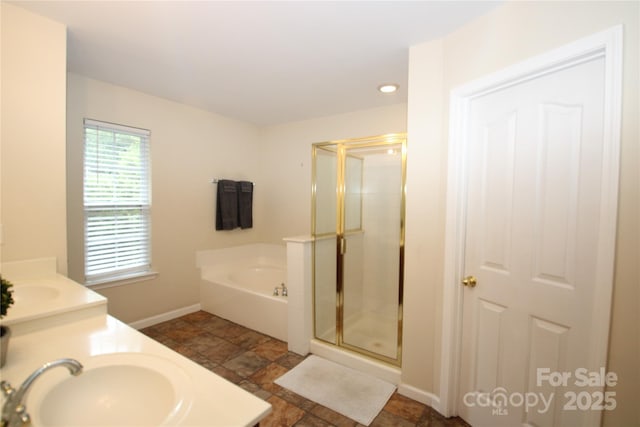 2418 Alaqua Ct, Matthews, NC 28105 - full bathroom featuring a bath, a shower stall, stone tile flooring, double vanity, and recessed lighting