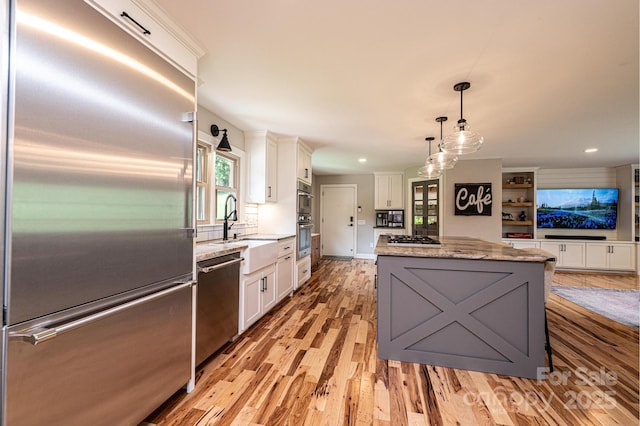 221 Roberts Ln, Lenoir, NC 28645 - kitchen featuring stainless steel appliances, white cabinets, a center island, light wood-style flooring, and recessed lighting