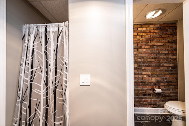 221 Roberts Ln, Lenoir, NC 28645 - full bathroom featuring a shower with curtain and brick wall