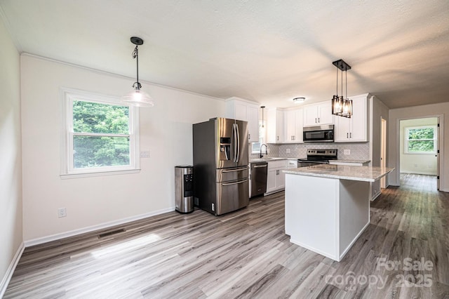 221 Roberts Ln, Lenoir, NC 28645 - kitchen featuring stainless steel appliances, wood finished floors, white cabinets, and decorative backsplash