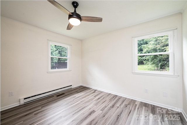 221 Roberts Ln, Lenoir, NC 28645 - empty room featuring a baseboard heating unit, wood finished floors, a ceiling fan, and crown molding