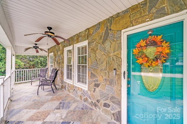 1004 Venus St, Kannapolis, NC 28083 - view of exterior entry featuring stone siding, covered porch, and ceiling fan