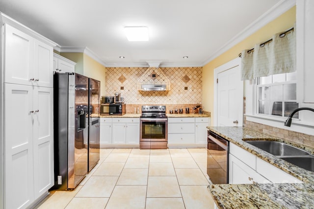 1004 Venus St, Kannapolis, NC 28083 - kitchen with appliances with stainless steel finishes, backsplash, ornamental molding, white cabinets, and light tile patterned floors