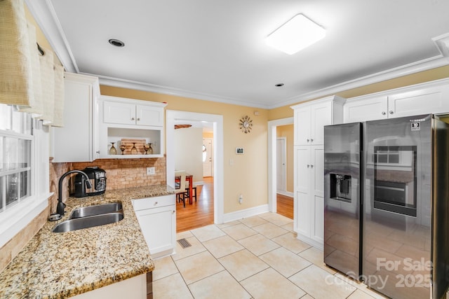 1004 Venus St, Kannapolis, NC 28083 - kitchen featuring stainless steel refrigerator with ice dispenser, open shelves, white cabinets, light stone counters, and ornamental molding