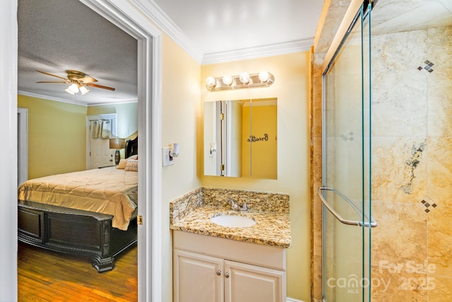 1004 Venus St, Kannapolis, NC 28083 - ensuite bathroom featuring ornamental molding, a shower stall, vanity, a ceiling fan, and wood finished floors