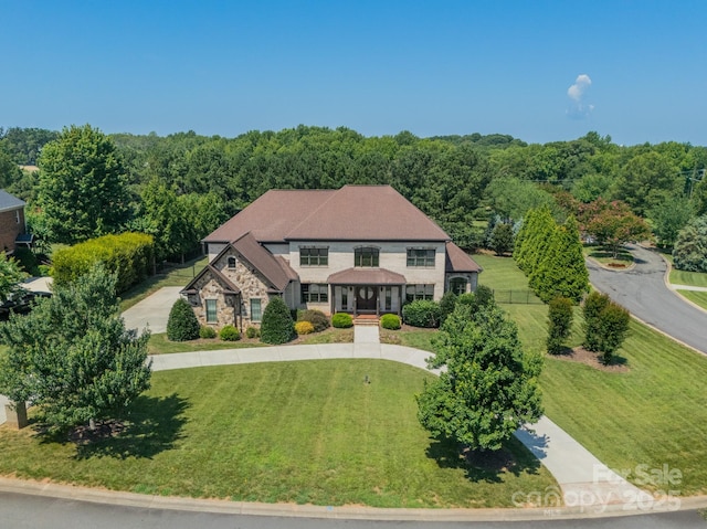 802 Capington Ln, Waxhaw, NC 28173 - view of front of house featuring stone siding, a front yard, and a wooded view