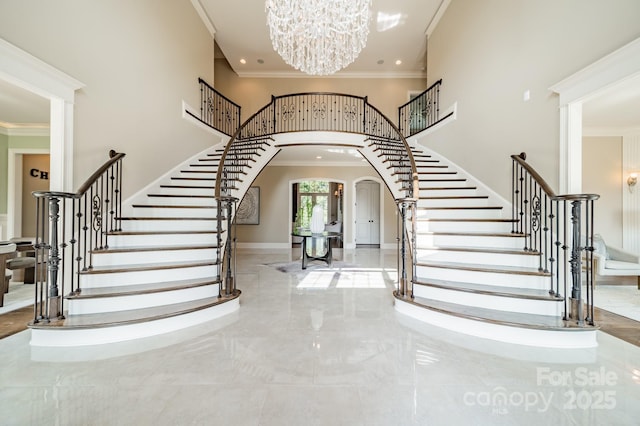 802 Capington Ln, Waxhaw, NC 28173 - entrance foyer with a high ceiling, stairs, arched walkways, crown molding, and a chandelier