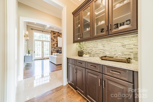 802 Capington Ln, Waxhaw, NC 28173 - bar with arched walkways, crown molding, decorative backsplash, light wood-style flooring, and beamed ceiling